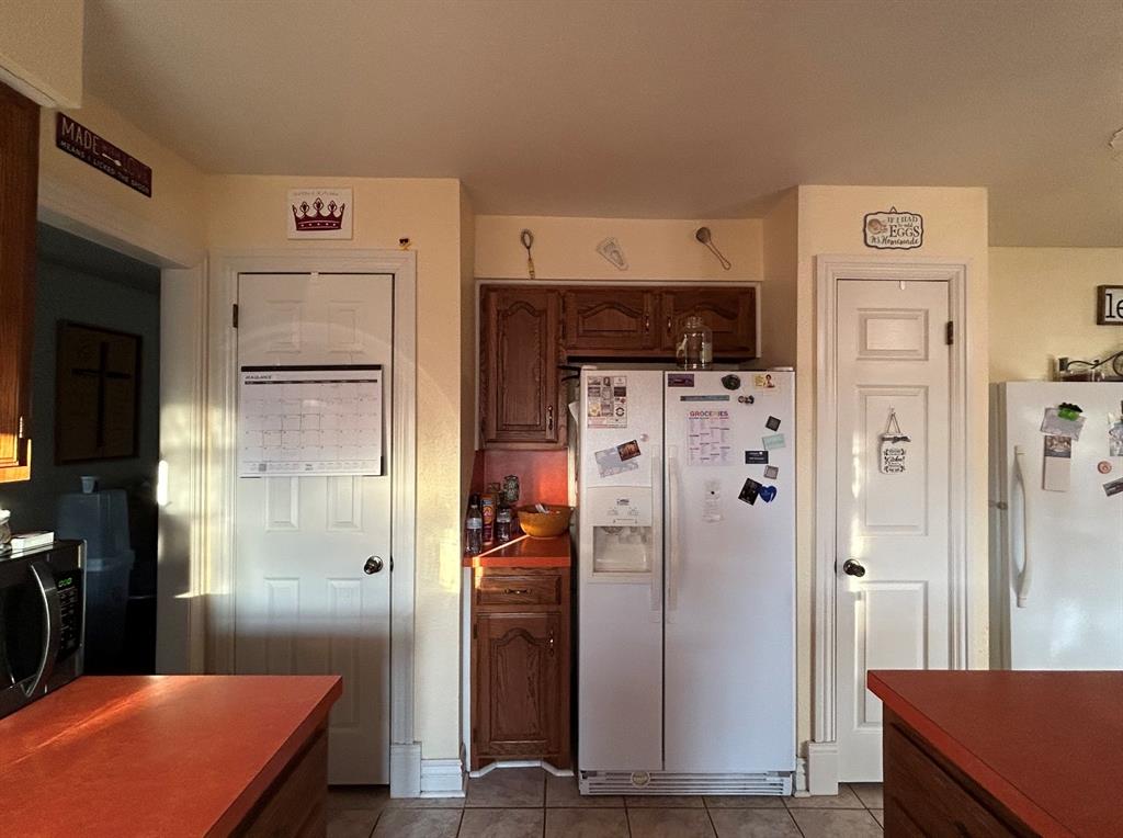 2020 Cedar Street Megargel, TX 76374 - Photo 13 of 29 a kitchen with stainless steel appliances a refrigerator and a stove