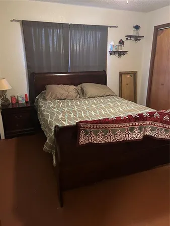 a bed sitting in a bedroom next to a window