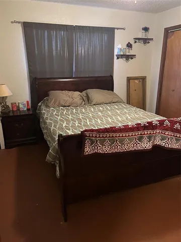 a bed sitting in a bedroom next to a window