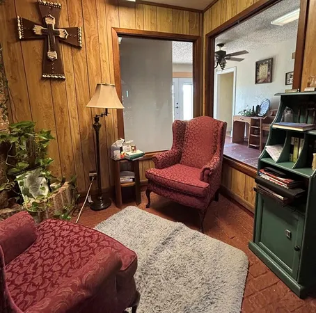a bedroom with furniture and a rug