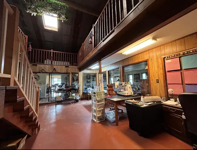 a living room with lots of furniture and a large window