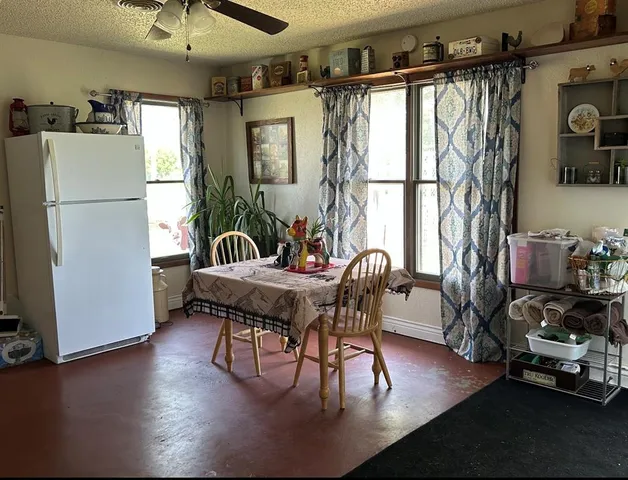 a dining room with furniture a window and wooden floor