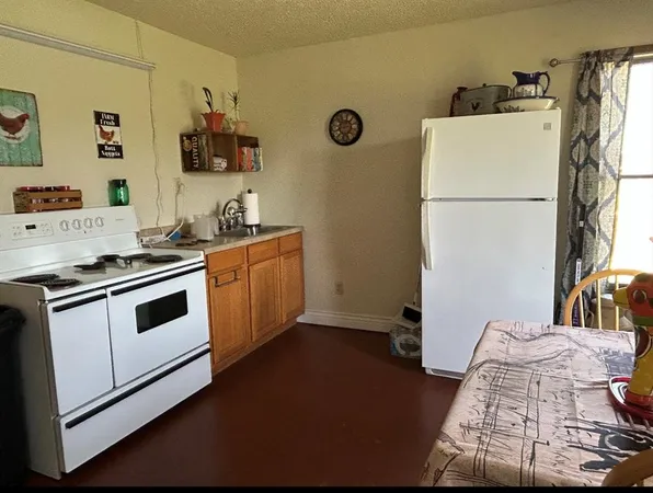 a kitchen with a refrigerator and a stove