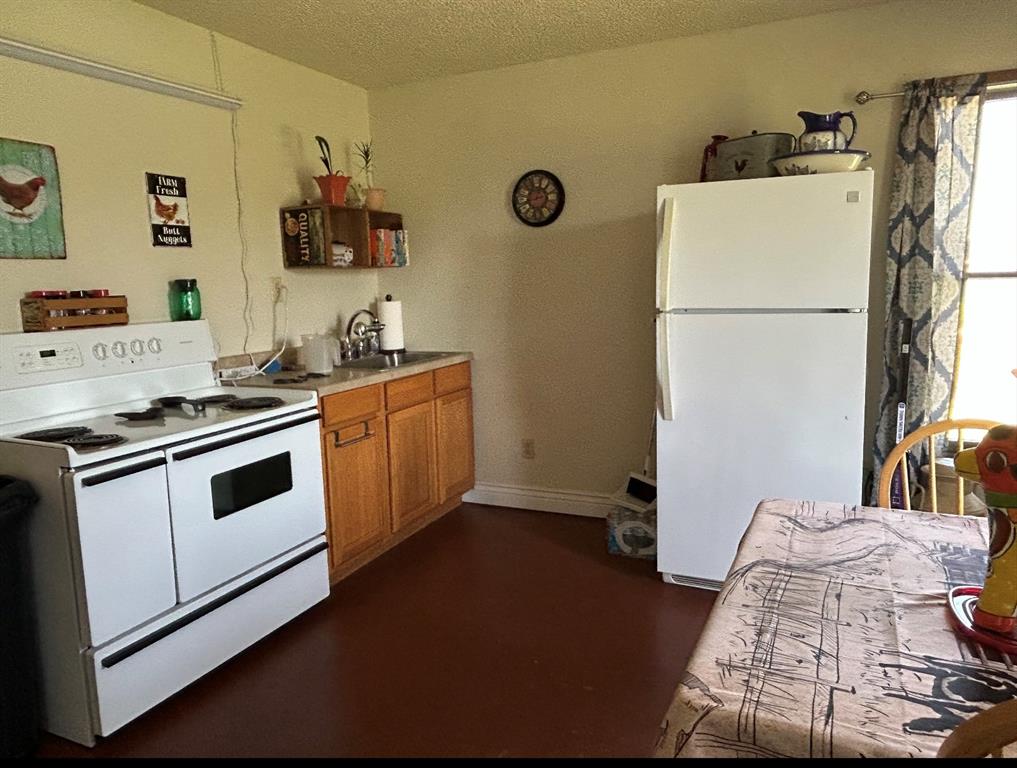 2020 Cedar Street Megargel, TX 76374 - Photo 29 of 29 a kitchen with a refrigerator and a stove