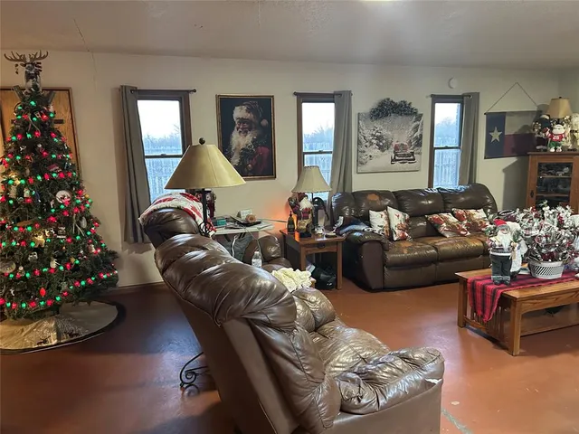 a living room with furniture flowerpot and flower vase