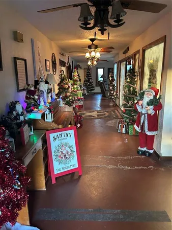 a view of a entryway with a flower pot and floor to ceiling window