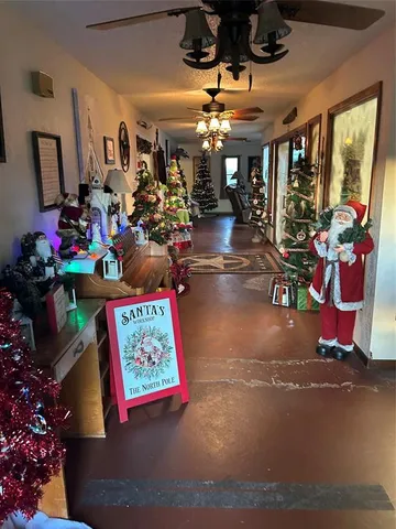 a view of a entryway with a flower pot and floor to ceiling window