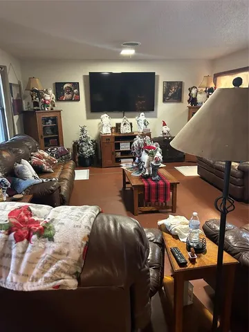 a living room with lots of furniture and a flat screen tv