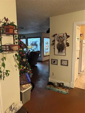 a room with painting on the wall and a potted plant