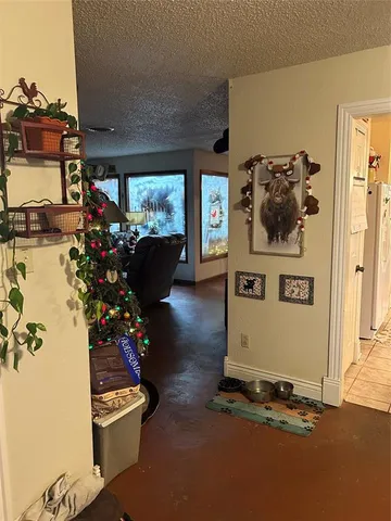 a room with painting on the wall and a potted plant