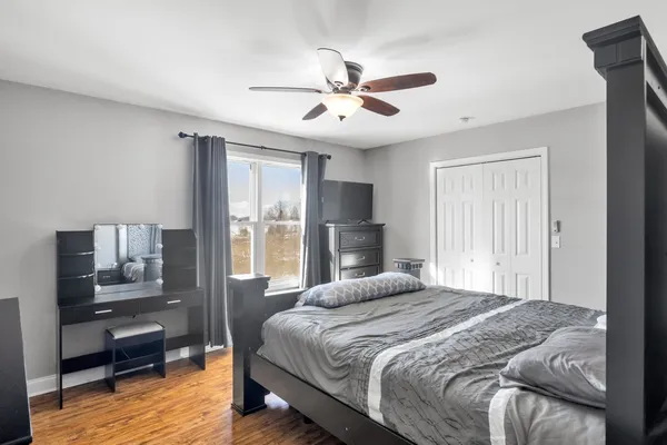 a bedroom with bed and a chandelier