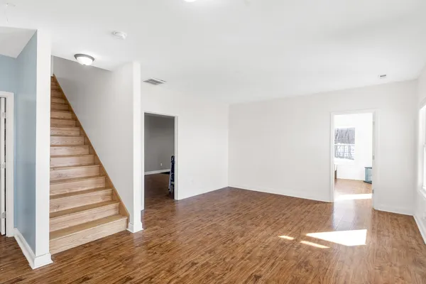 a bedroom with furniture and wooden floor