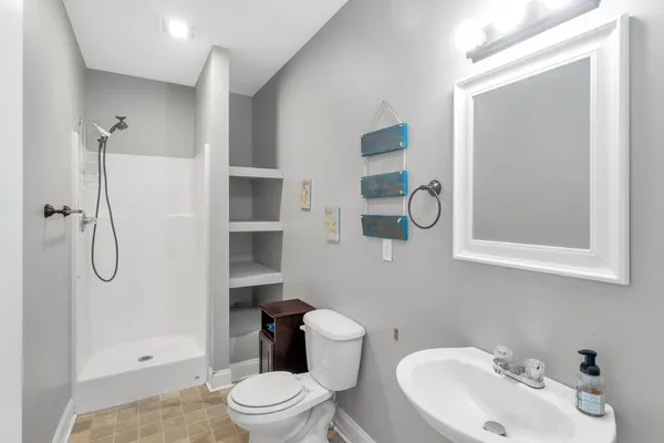 a view of a terrace with wooden fence and two trees