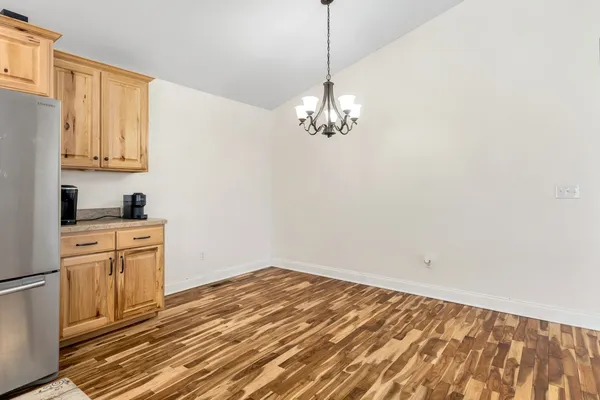a kitchen with a refrigerator a microwave a sink and cabinets