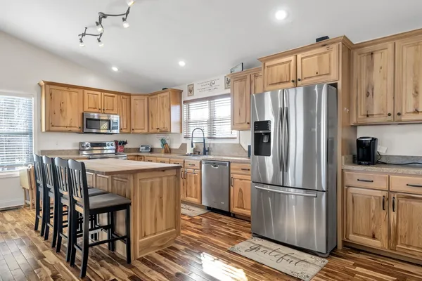a kitchen with a stove a sink and a microwave