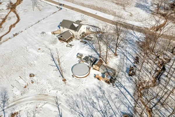 a view of a house with snow on the road