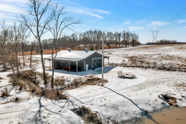 a view of a house with snow on the road