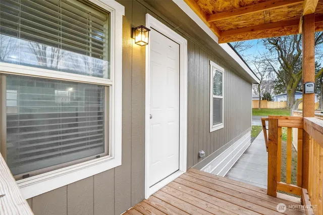 a view of a kitchen with wooden floor and windows