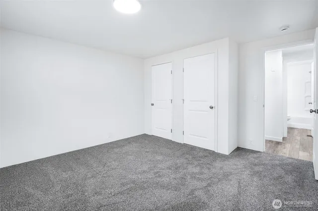 a view of an empty room with windows