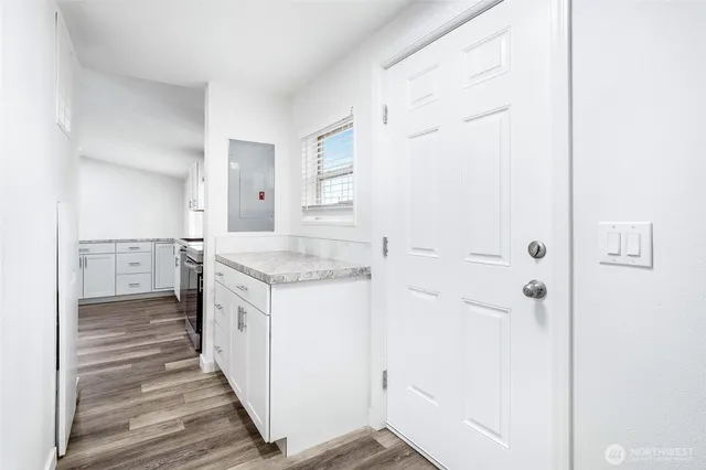a view of empty room with wooden floor