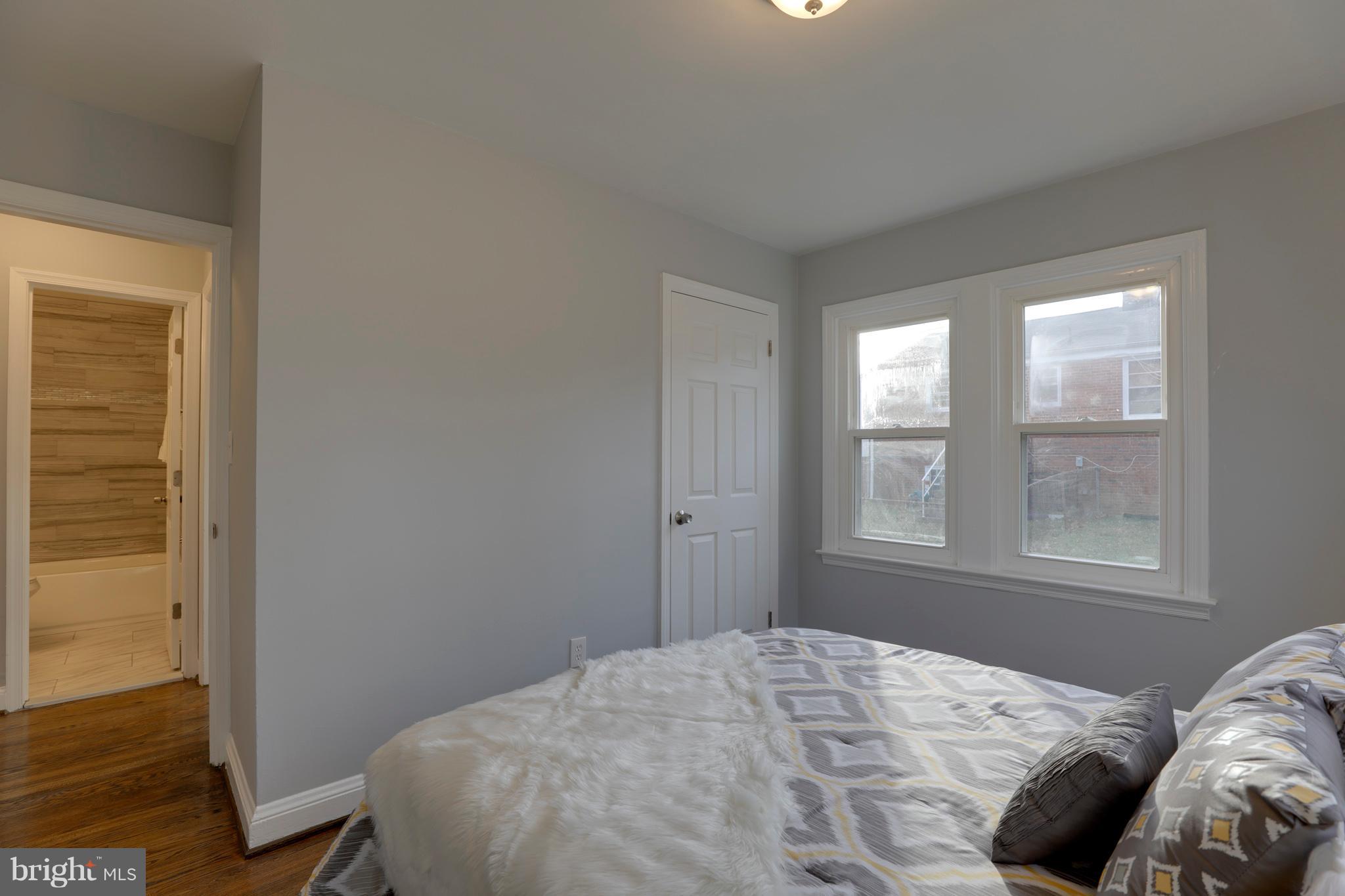 6203 Woodley Road Clinton, MD 20735 - Photo 17 of 38 a bedroom with a bed and wooden floor