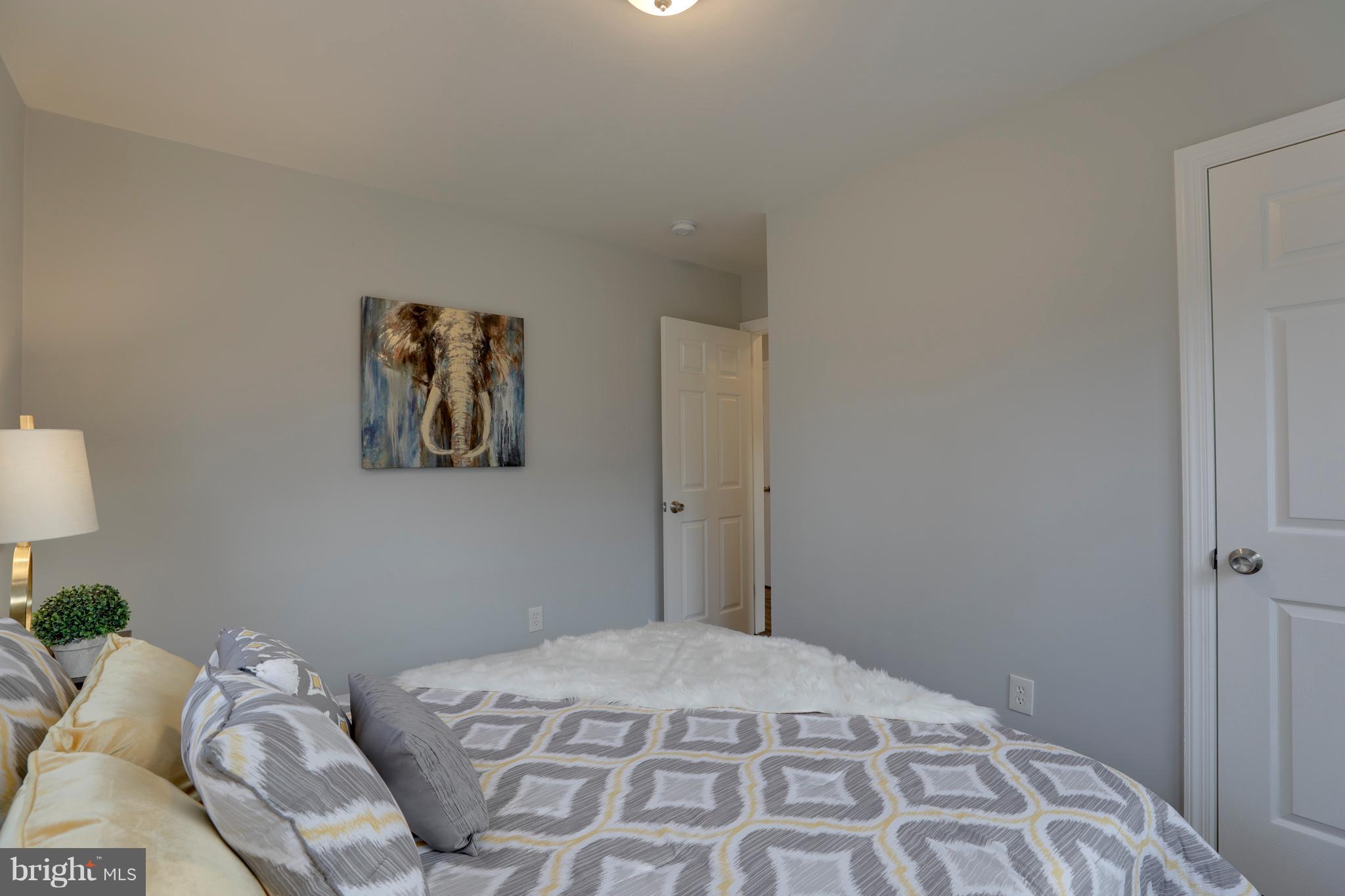 6203 Woodley Road Clinton, MD 20735 - Photo 19 of 38 a bedroom with a bed and a painting on the wall