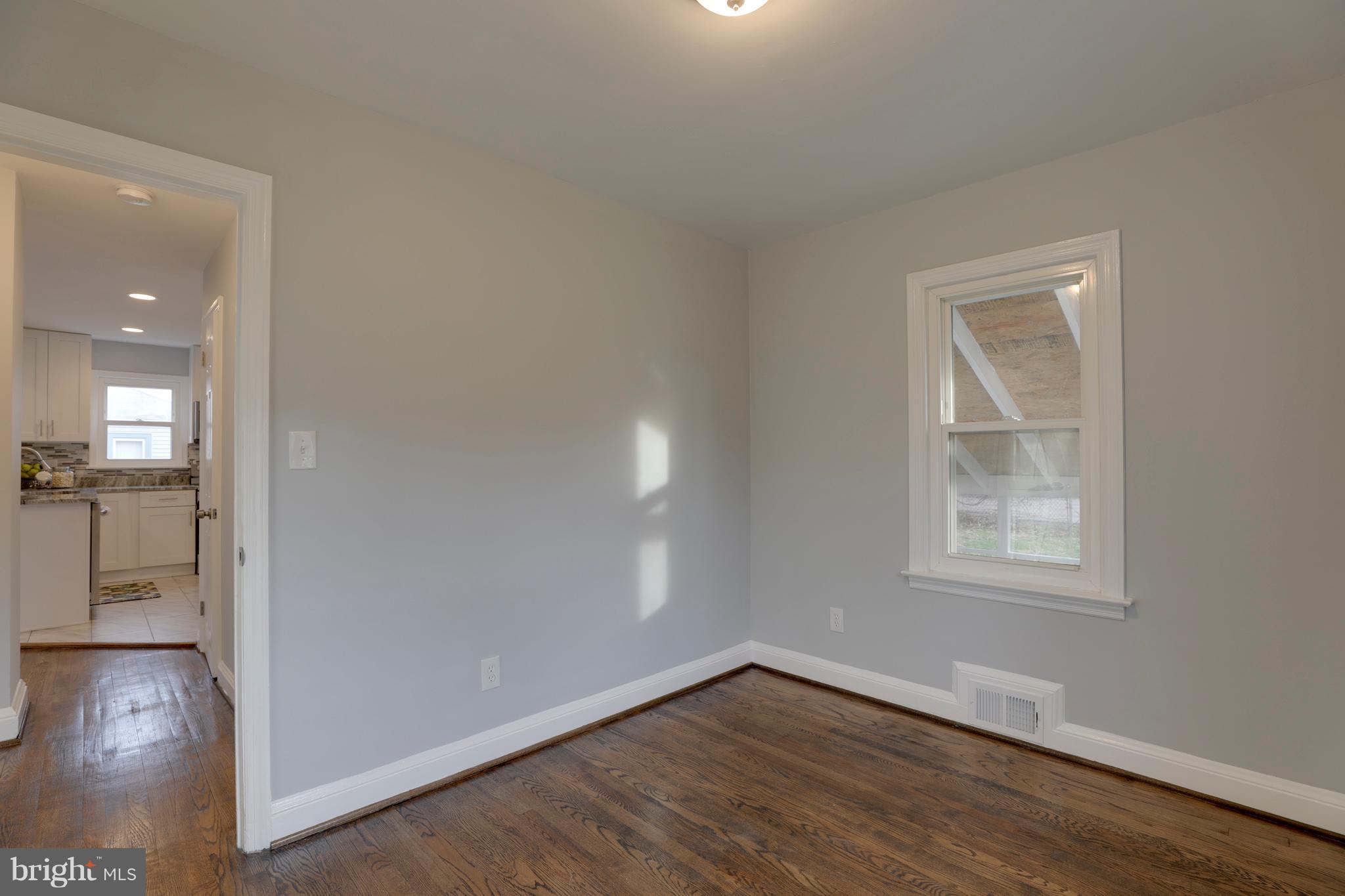 6203 Woodley Road Clinton, MD 20735 - Photo 21 of 38 an empty room with wooden floor and windows
