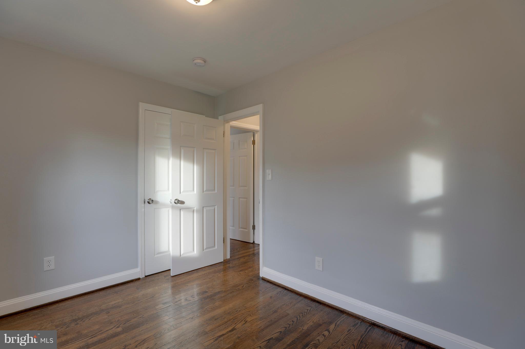 6203 Woodley Road Clinton, MD 20735 - Photo 22 of 38 a view of an empty room and wooden floor