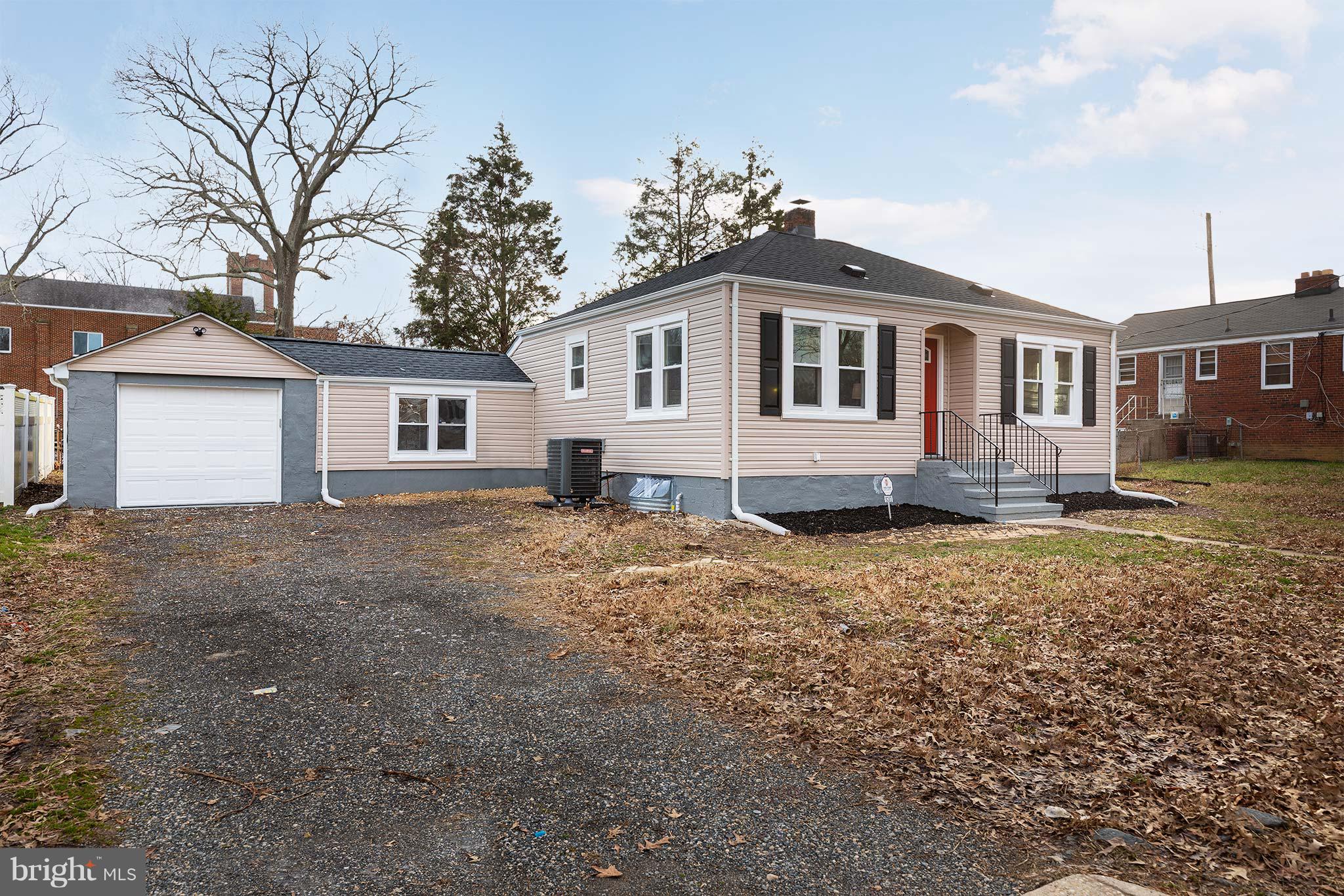 6203 Woodley Road Clinton, MD 20735 - Photo 37 of 38 a front view of a house with a yard