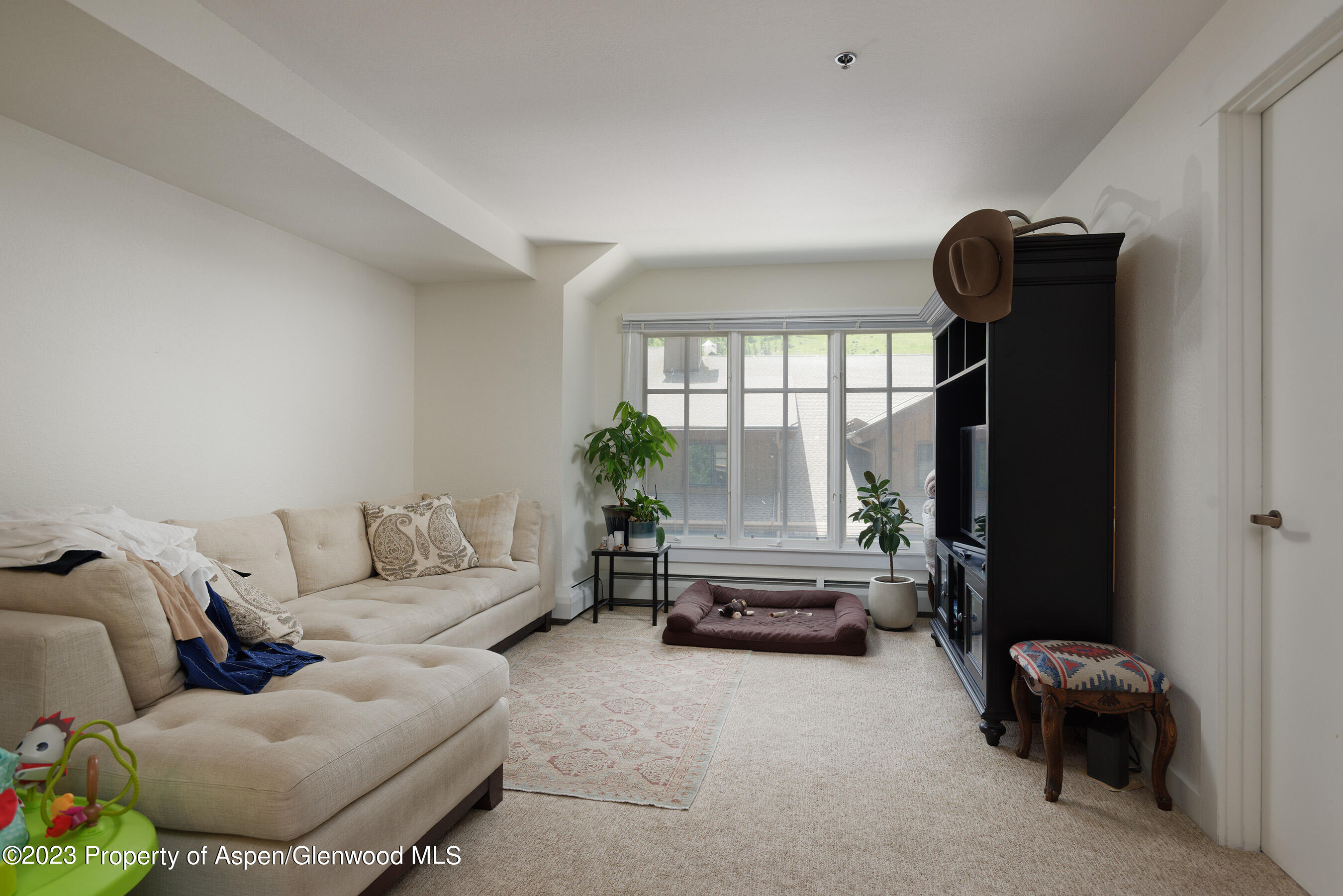 115 Boomerang Road, Unit 5401 Aspen, CO 81611 - Photo 1 of 7 a living room with furniture and a window