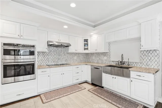 a kitchen with granite countertop white cabinets and white appliances
