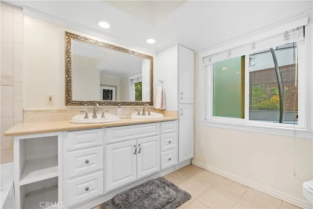 a bathroom with a double vanity sink and a mirror