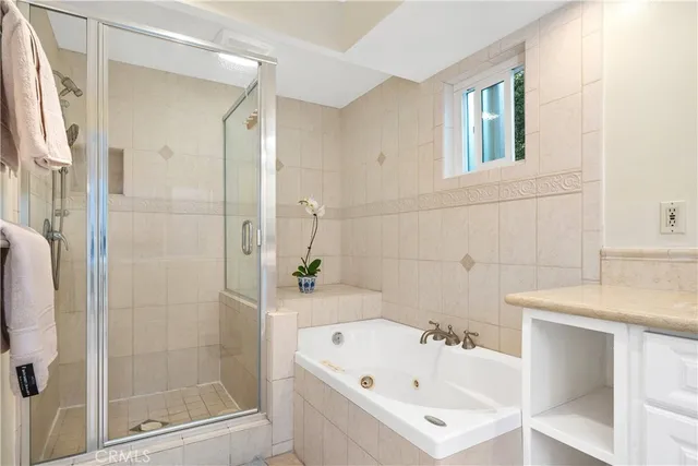 a bathroom with a tub sink and mirror