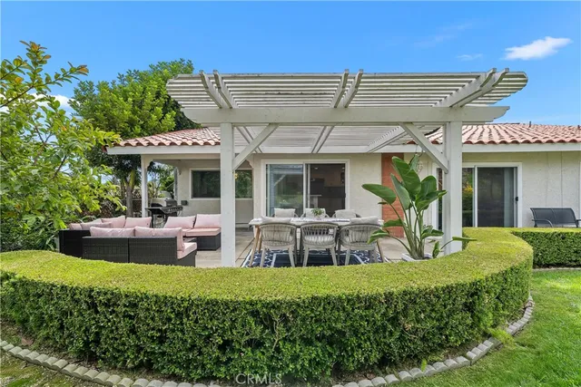 a view of a house with a couches chair and tables
