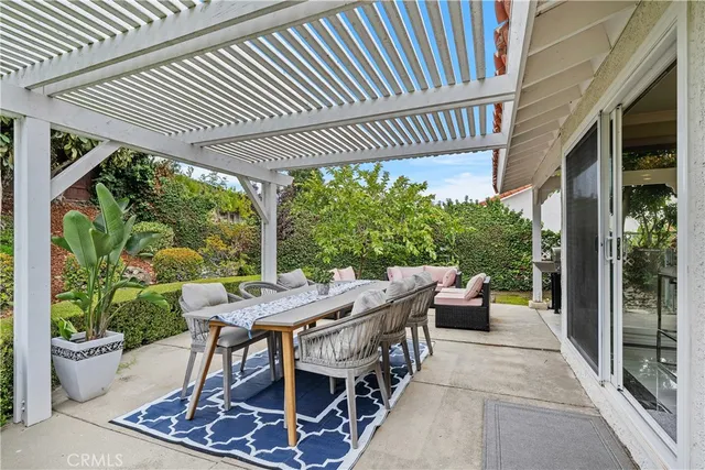 a view of a patio filled with furniture and garden view