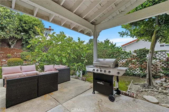 a backyard of a house with yard barbeque oven and outdoor seating