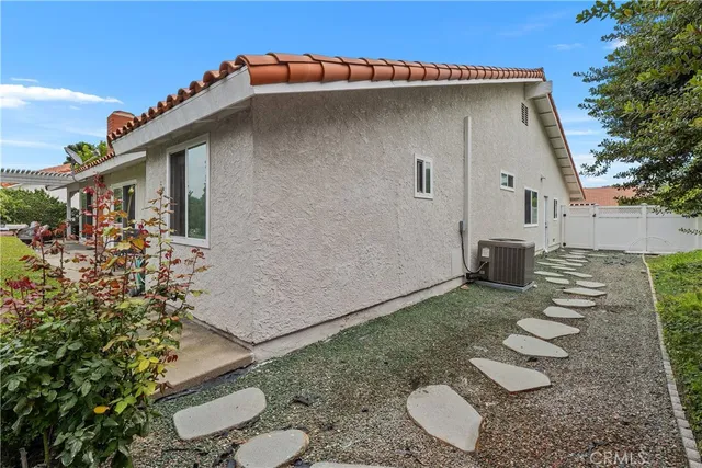 a backyard of a house with chairs
