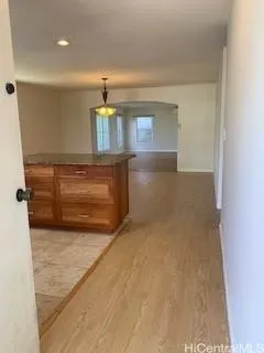 a view of kitchen with refrigerator and window