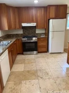 a kitchen with cabinets and white appliances