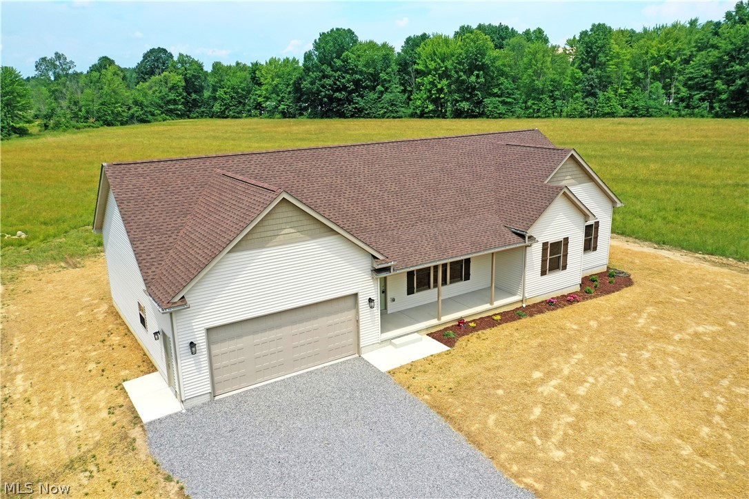6834 Palmyra Road Southwest Warren, OH 44481 - Photo 4 of 33 View of front facade featuring a garage and a front yard