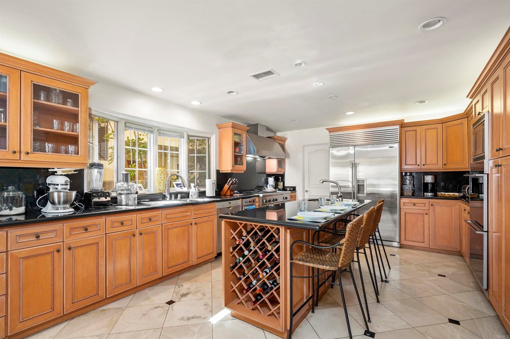 42 Blue Anchor Cay Road Coronado, CA 92118 - Photo 13 of 38 a kitchen with granite countertop lots of white cabinets a sink and dishwasher