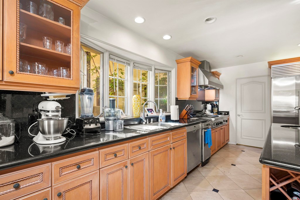 42 Blue Anchor Cay Road Coronado, CA 92118 - Photo 14 of 38 a kitchen with sink a stove and cabinets