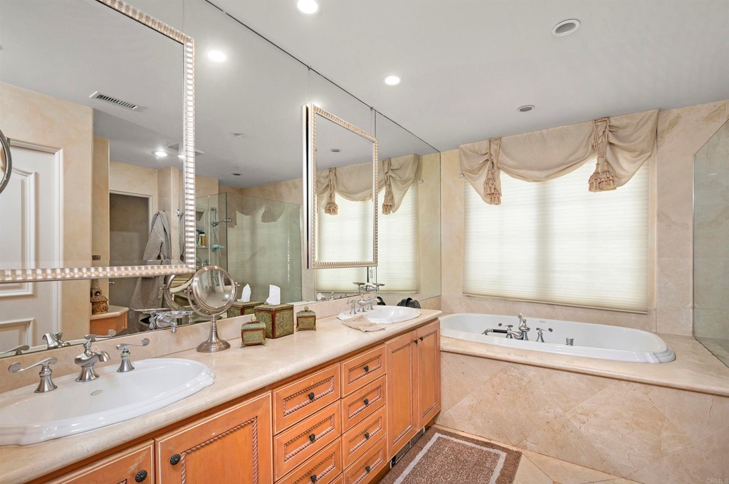 42 Blue Anchor Cay Road Coronado, CA 92118 - Photo 23 of 38 a bathroom with a double vanity sink large mirror and a bathtub