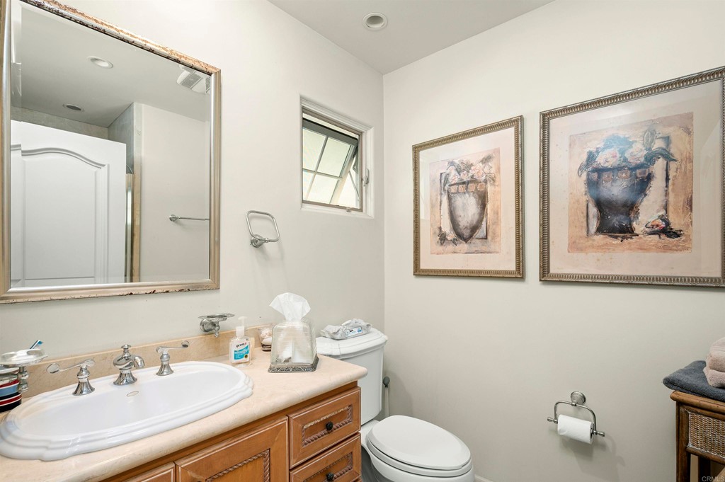 42 Blue Anchor Cay Road Coronado, CA 92118 - Photo 30 of 38 a bathroom with a sink mirror and toilet