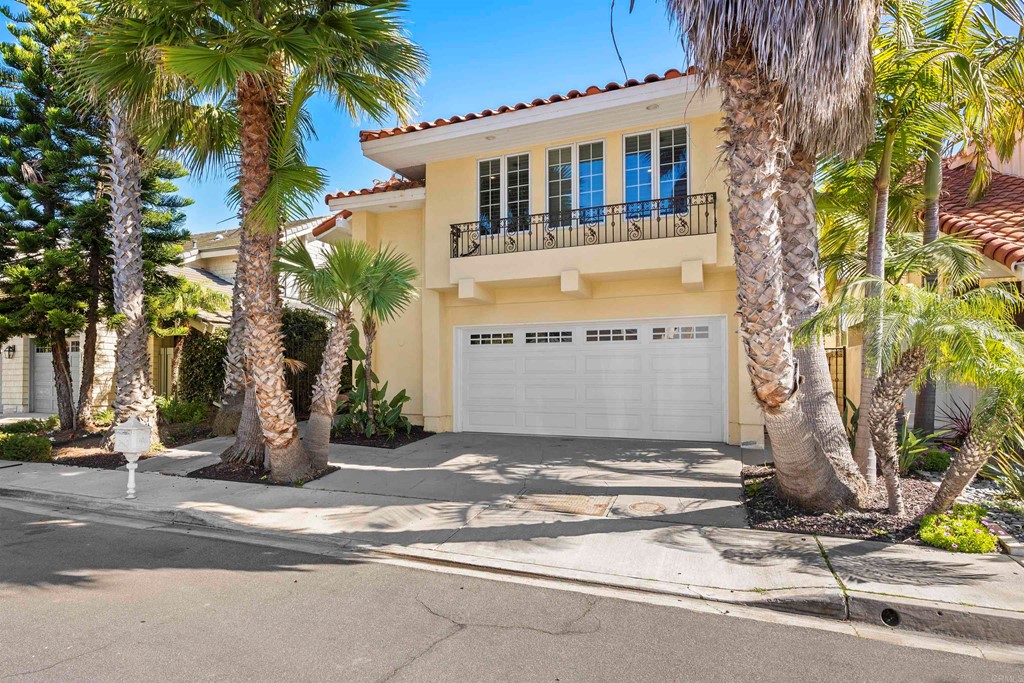 42 Blue Anchor Cay Road Coronado, CA 92118 - Photo 3 of 38 a front view of a house with a garden and tree