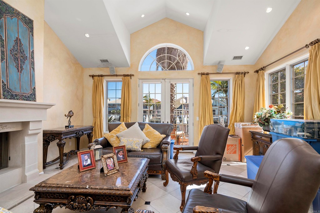 42 Blue Anchor Cay Road Coronado, CA 92118 - Photo 9 of 38 a living room with furniture fireplace and large windows