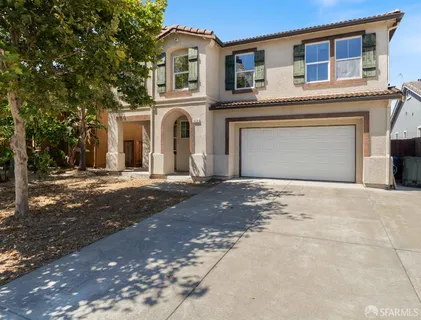 a front view of a house with a road