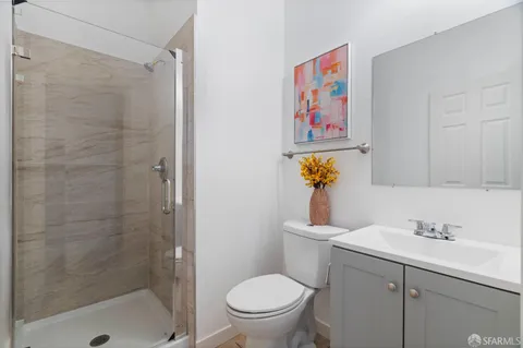 a bathroom with a sink a toilet and shower