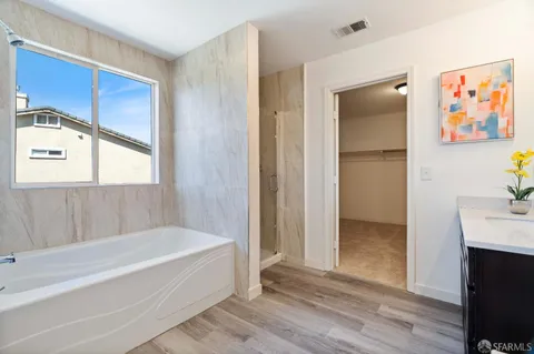 a spacious bathroom with a tub and a shower