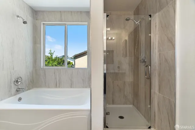 a bathroom with a bathtub and a shower